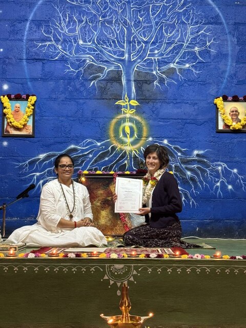 Fedra next to her Indian yoga teacher holding certificate